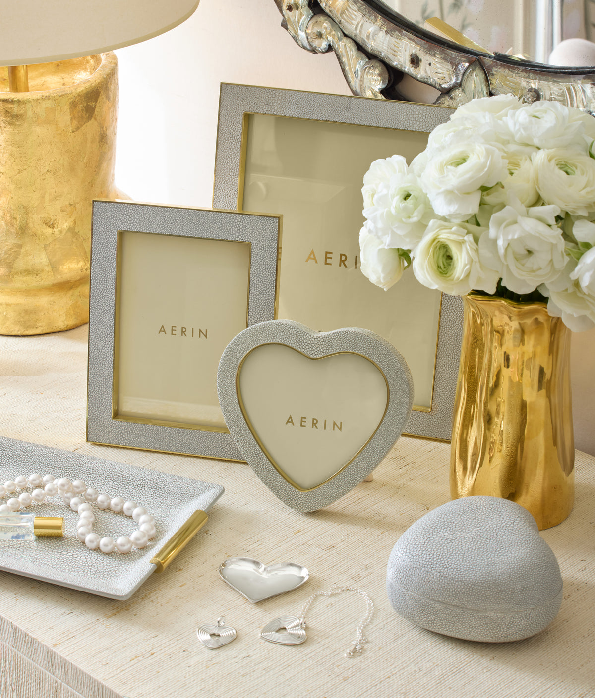 Small dove shagreen vanity tray displayed on a dresser with matching shagreen frames, pearl necklace, and gold vase