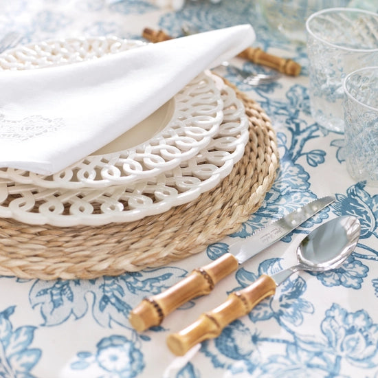 Close-up of Bamboo Flatware, Set of 5 showcasing bamboo handles and stainless steel utensils with a patterned table setting