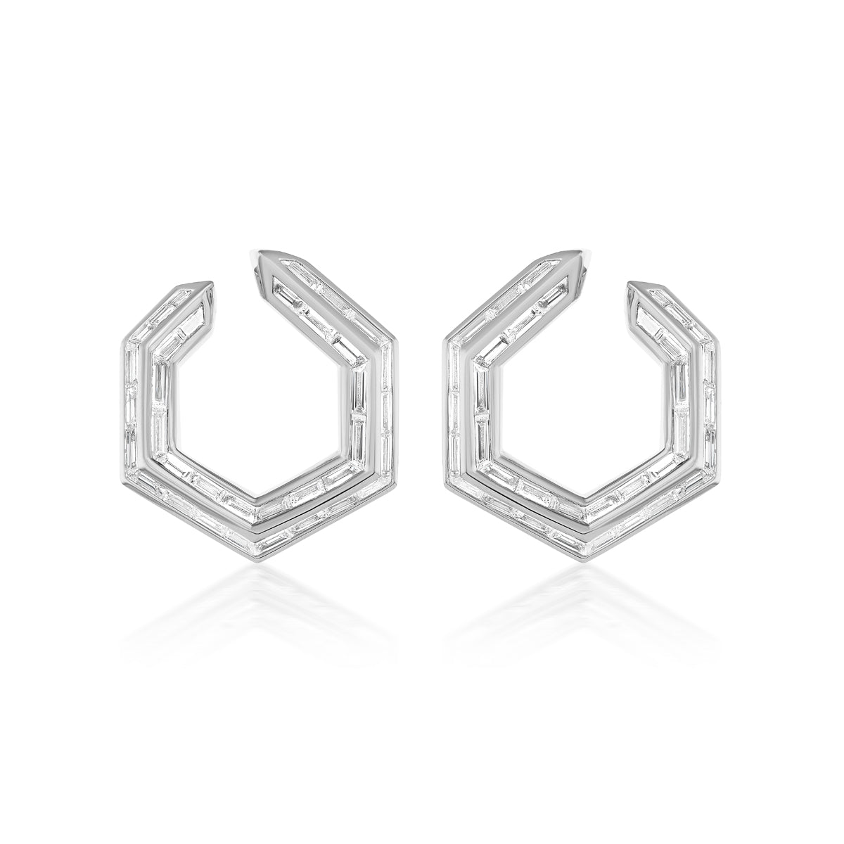 The Chrysler Front-To-Back Hoops with Baguette Diamonds are geometric hexagonal silver earrings, each edge set with small rectangular diamonds, shown on a white background.