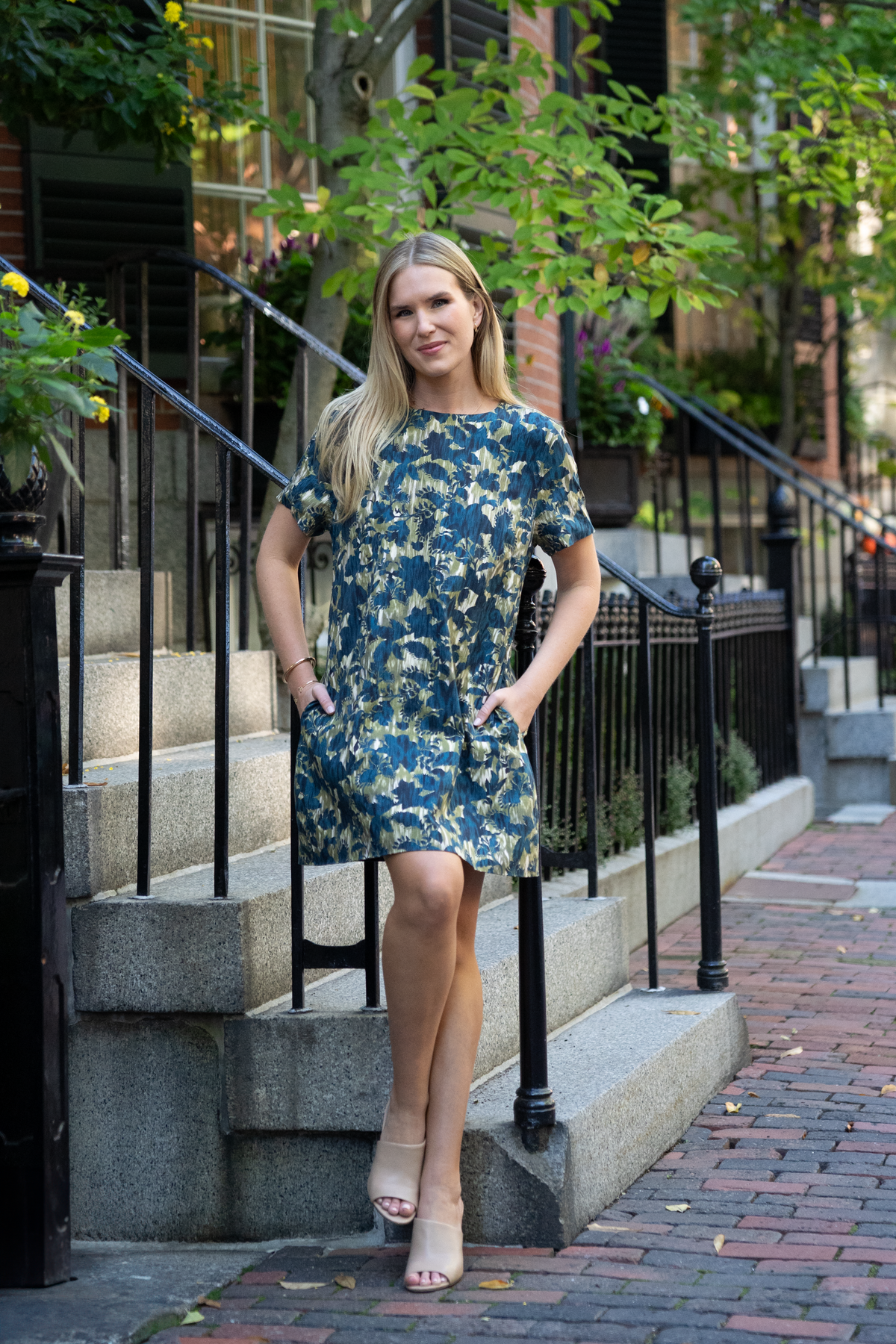 Front view of Sandrine Dress in Cinque Terre Navy showing its mini shift style, crew neckline, and side pockets outdoors