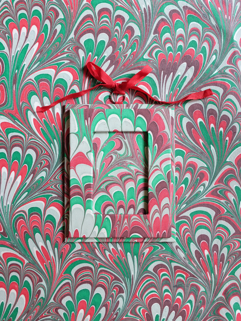 Holiday picture frame ornament in festive marble pattern on matching background