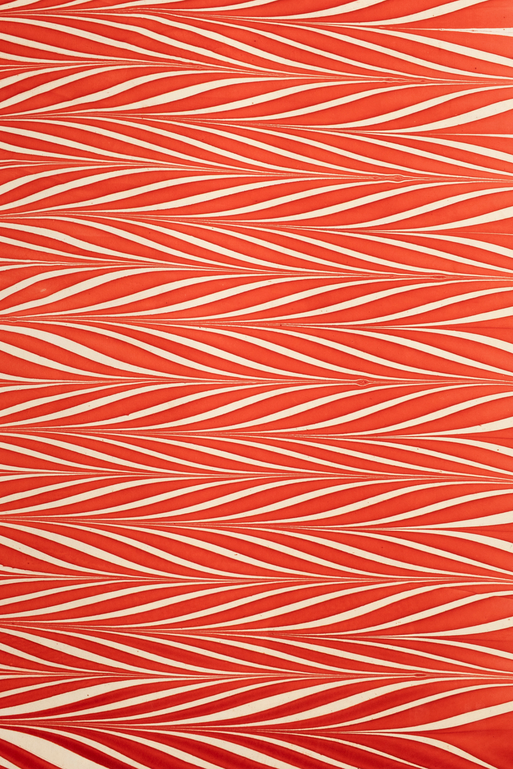 Red and white striped hand marbled candy cane gift wrapping paper sheet close-up