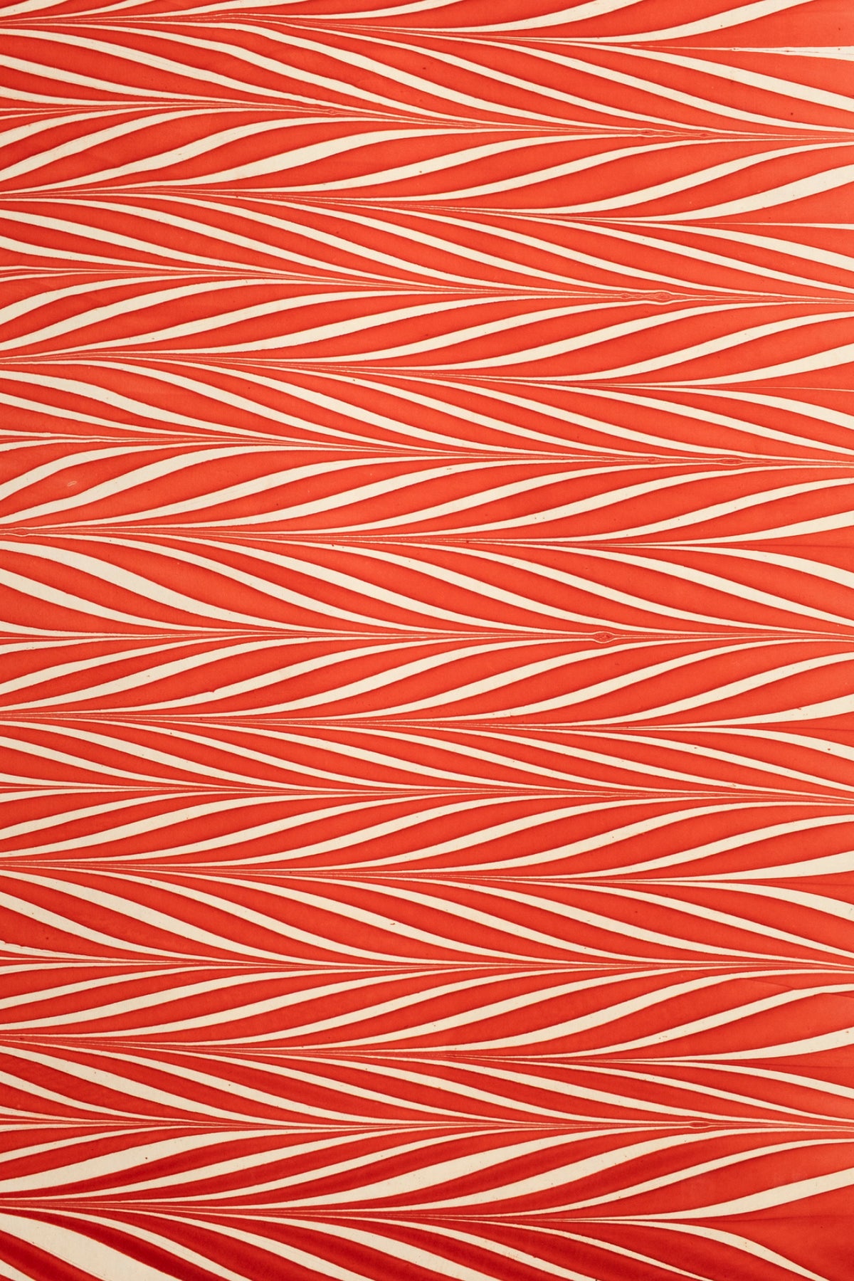 Red and white striped hand marbled candy cane gift wrapping paper sheet close-up