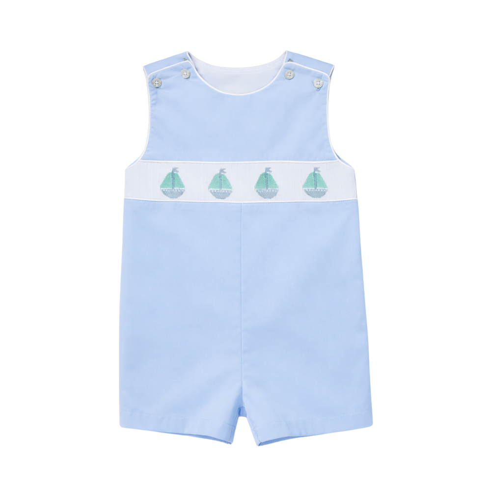 Front view of George Jon Jon in Bailey’s Bay Blue with hand-smocked sailboat band and shoulder button closures on white background