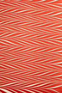Red and white striped hand marbled candy cane gift wrapping paper sheet close-up