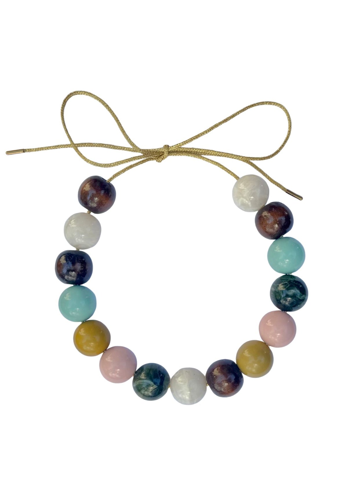 Top-down view of Vermont Bubble Necklace showcasing multicolored round beads on a gold lurex cord tied in a bow on a white background