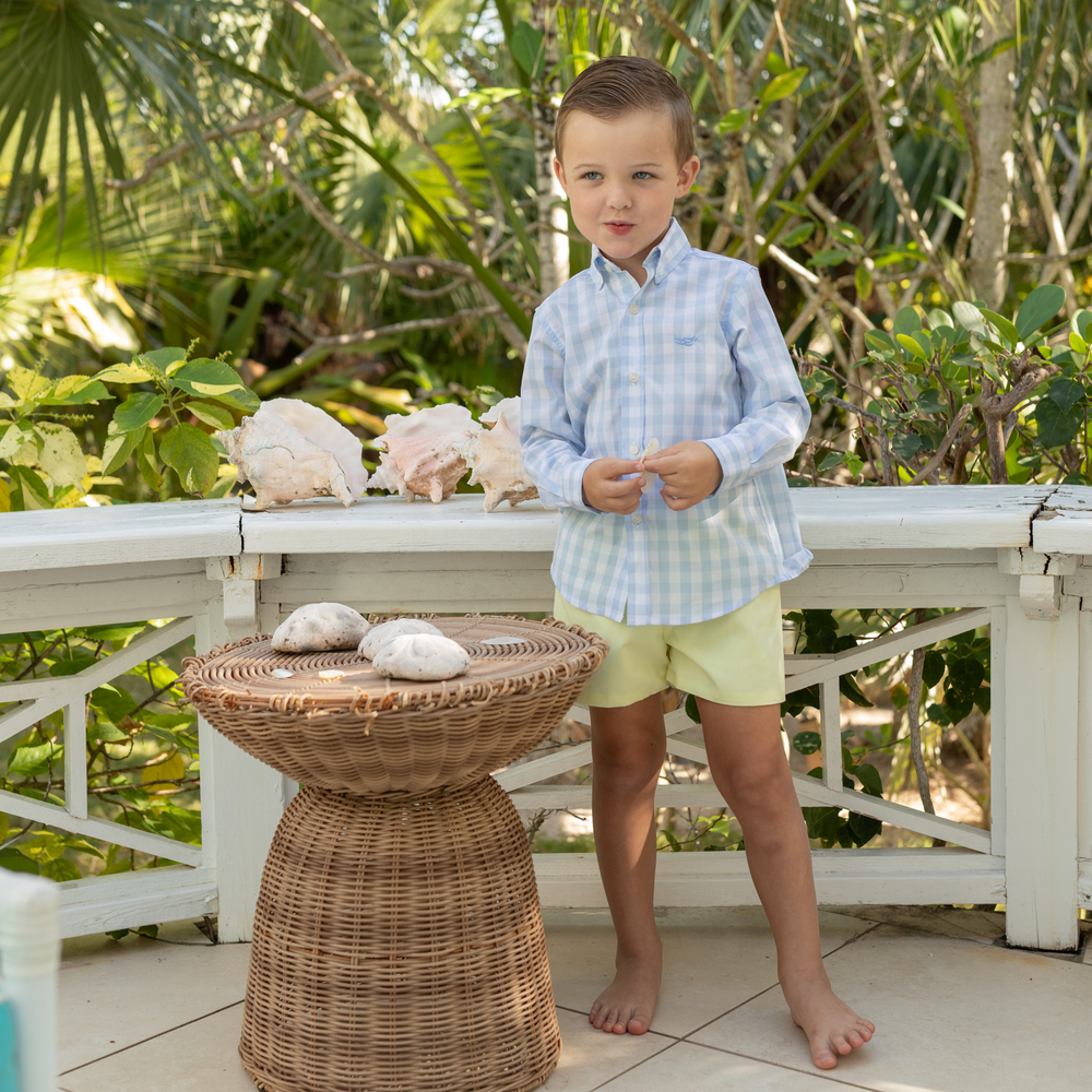 Front view of Robert Shorts in South Street Sunshine showcasing flat front and elastic back waistband on a child model on a sunny porch