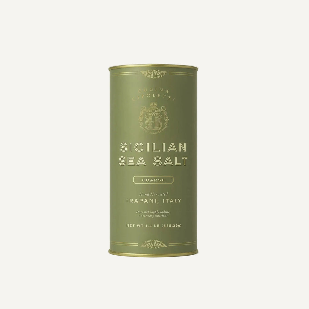 Green canister of Sicilian sea salt on a white background