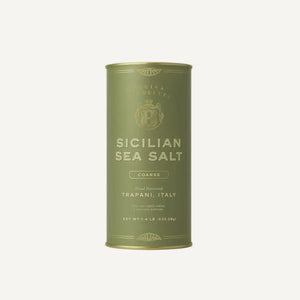 Green canister of Sicilian sea salt on a white background