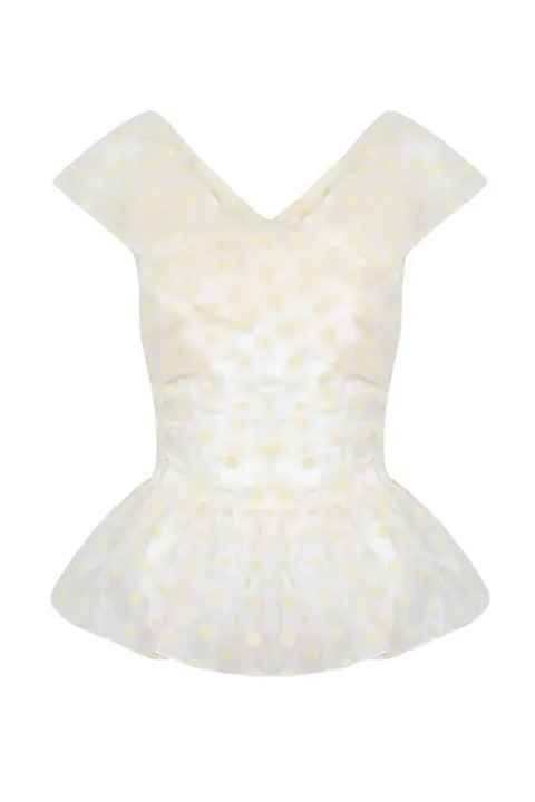 Front view of Clemence sleeveless peplum top in organza with pale yellow polka dots, ruched fitted waist and V-neck on white background