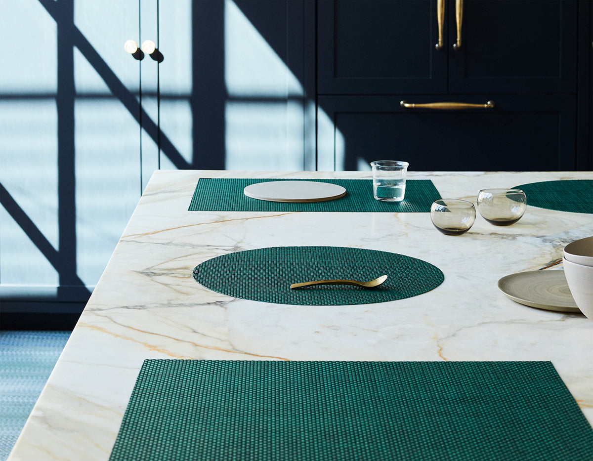 Angled view of Basketweave rectangular placemat in pine showcasing woven texture on a set dining table