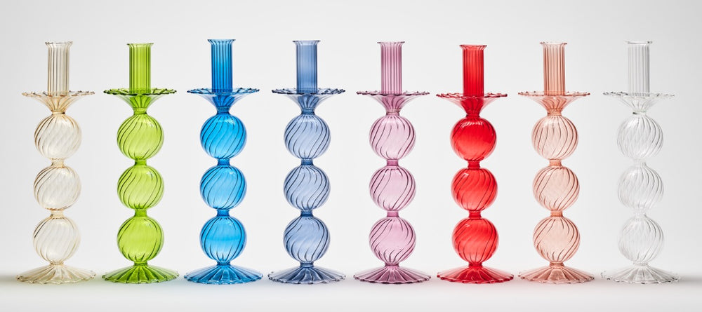 Front view of Iris tall hand-blown glass candle holders in assorted colors showing stacked globe design and scalloped base on white background