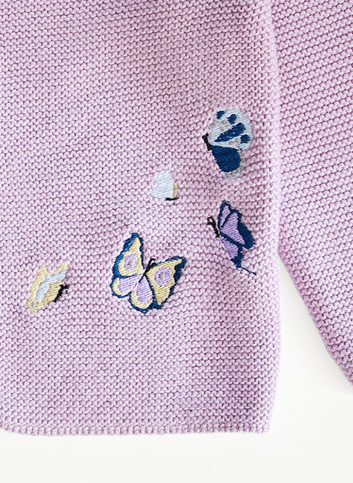 Close-up of Embroidered Butterfly Knit Cardigan showing lavender garter-knit texture and multicolor embroidered butterflies on white background