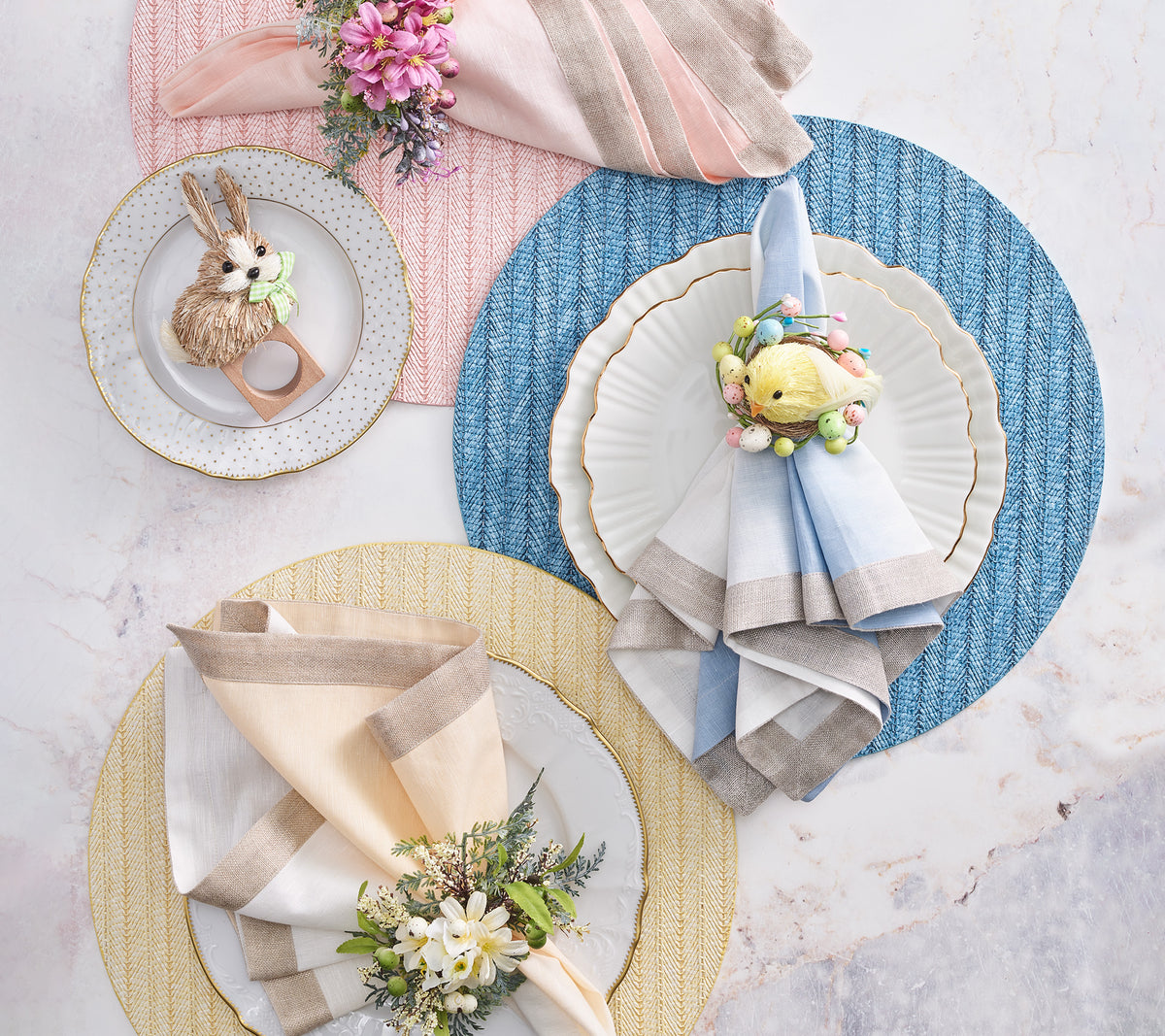 Overhead view of Dip Dye linen napkins in white and beige showcasing ombré dip-dye and metallic foil border with decorative plates and pastel placemats