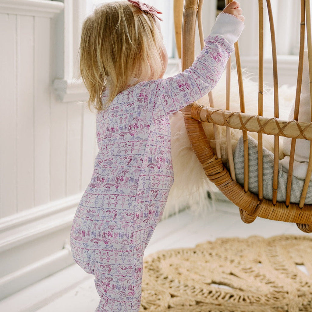 joy street ballet print baby zip onesie on model 