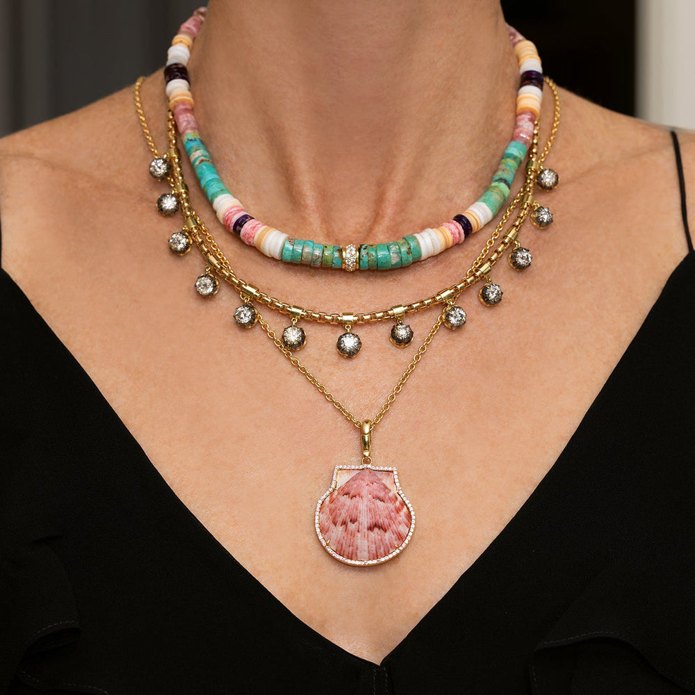 Front view of Natural Shell in Pink Sapphire Frame charm showing pink shell in sapphire halo and 18k yellow gold bail