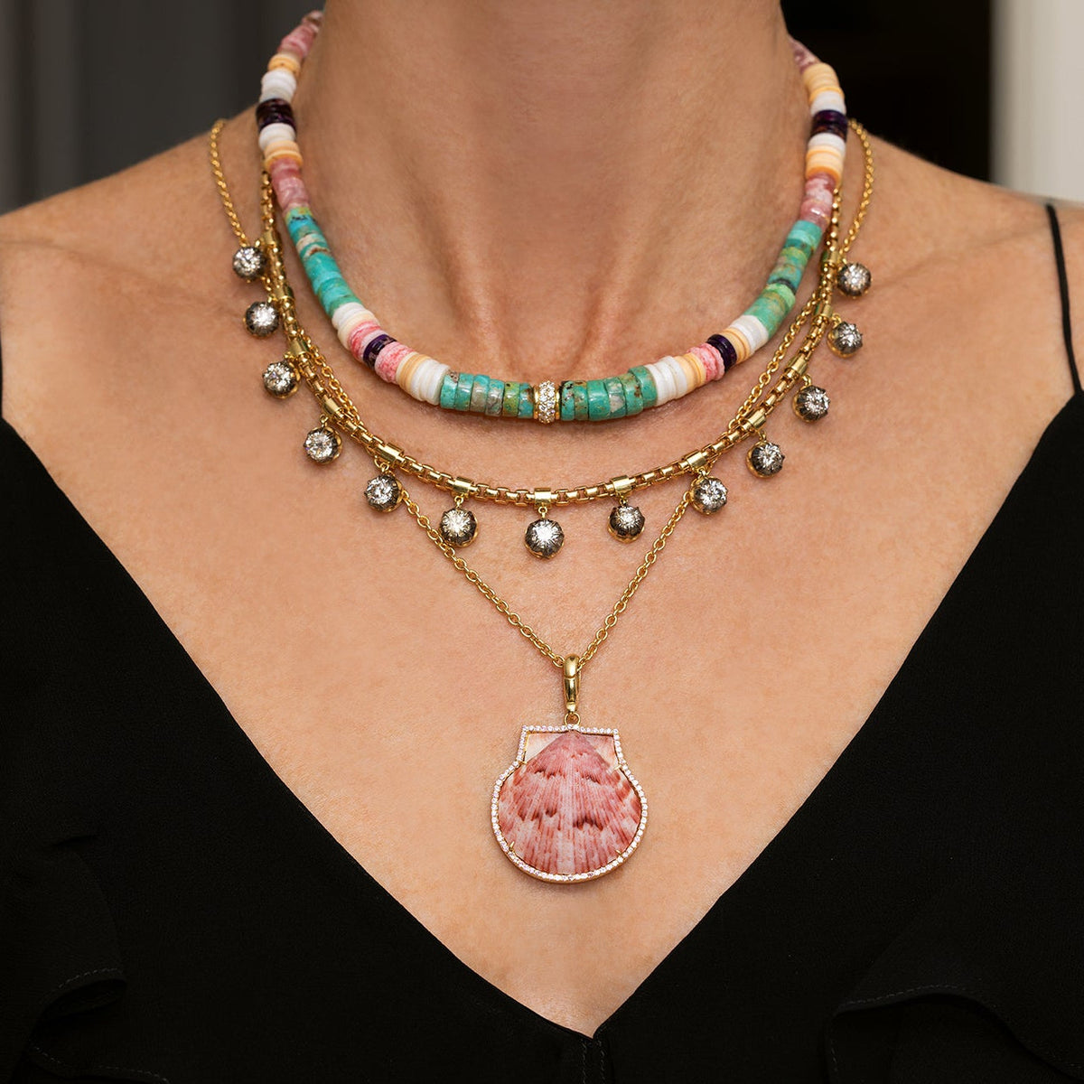 Front view of Natural Shell in Pink Sapphire Frame charm showing pink shell in sapphire halo and 18k yellow gold bail