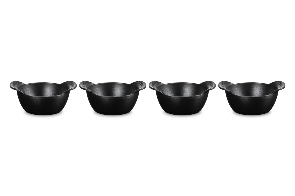 Front view of four Mini Round Cocotte Bases in matte black showcasing curved handles and open interiors on white