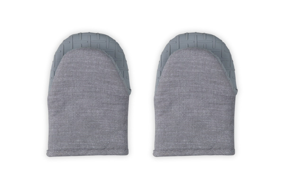 Top view of pair of 8-inch mini oven mitts in Charbon showing patterned silicone grip and soft terry exterior on white