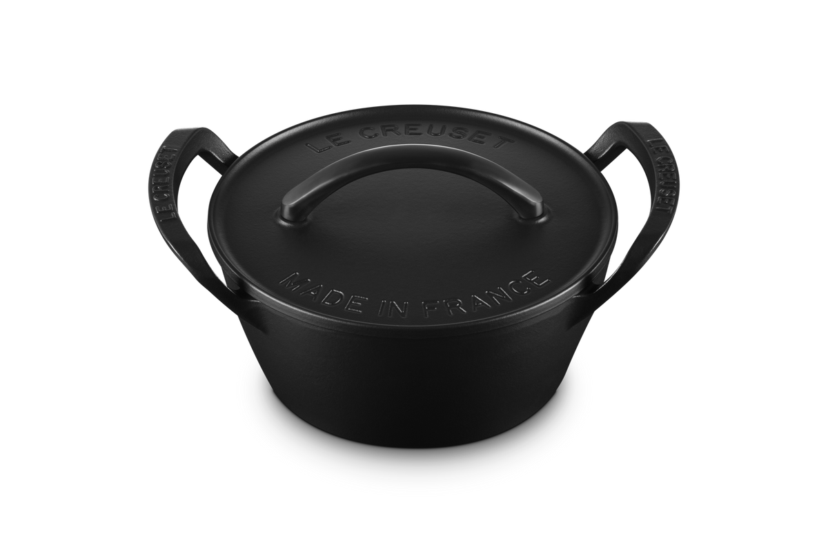 Top view of Alpine Outdoor 4.25 qt. Round Dutch Oven showcasing matte black domed lid and loop handles on white background