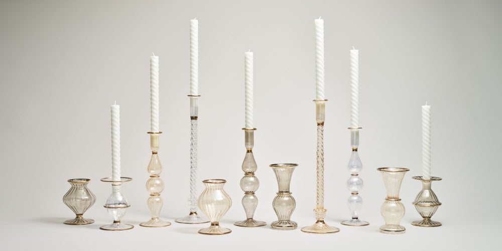 Front view of Scallop Bud Vase and matching candlesticks in smoke mouth-blown iridescent glass with 18K gold rims on a neutral background