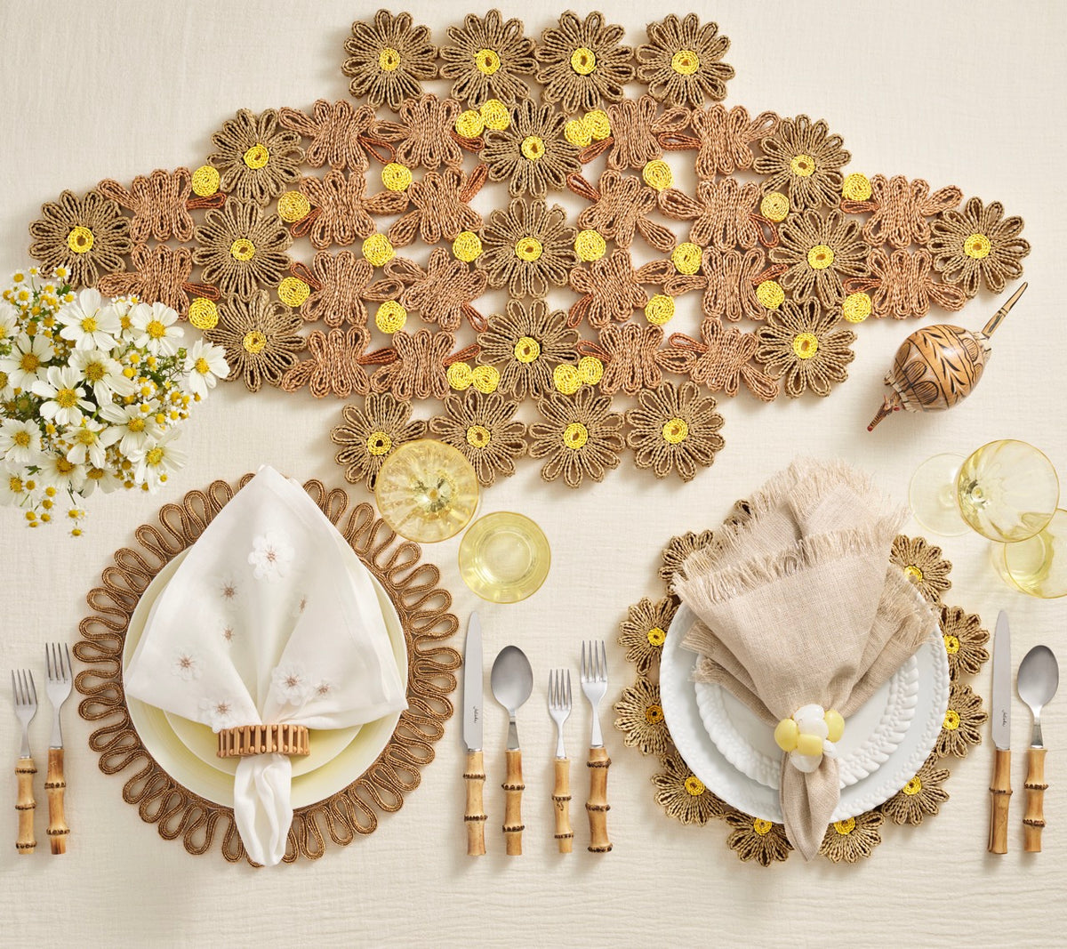 Top view of Daisy Table Runner in Natural and Ivory showcasing handwoven wheat straw daisy motifs on a styled dining table