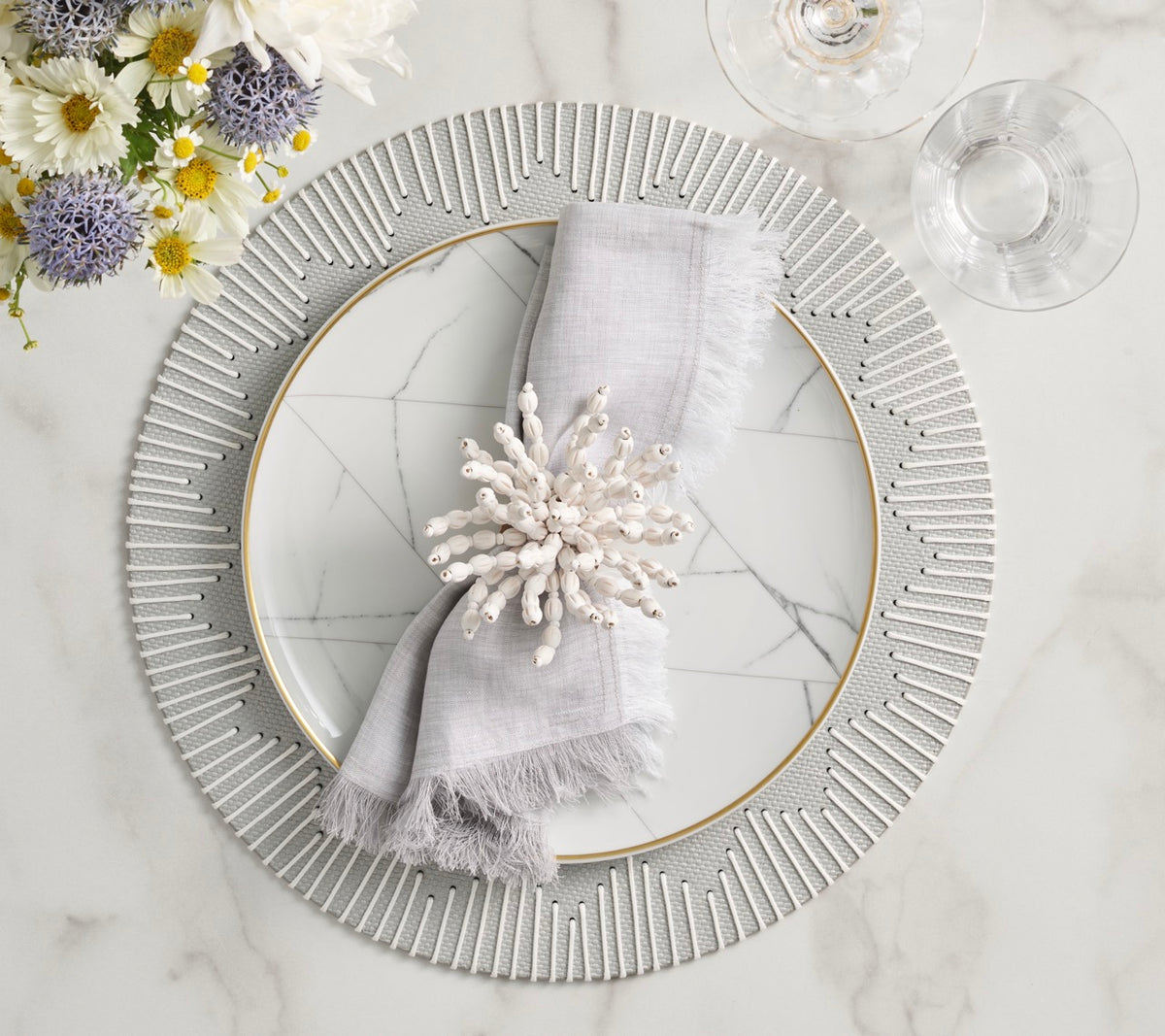 Overhead view of Dream Weaver Placemat in Gray and White, Set of 4 showcasing radiating white stripes on a styled table