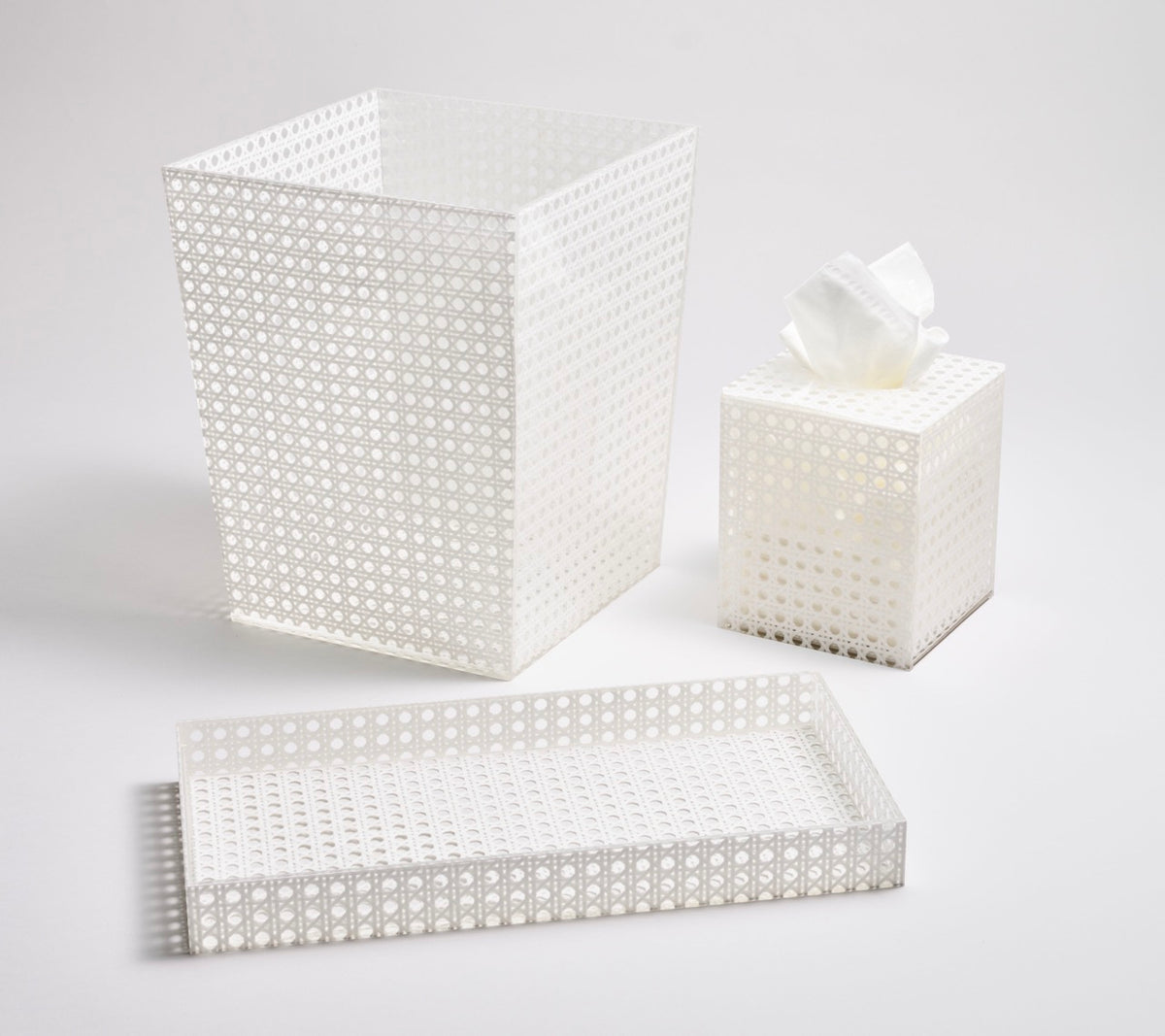 Angled view of Reed Waste Basket in White showcasing signature reed pattern with matching tissue box and vanity tray