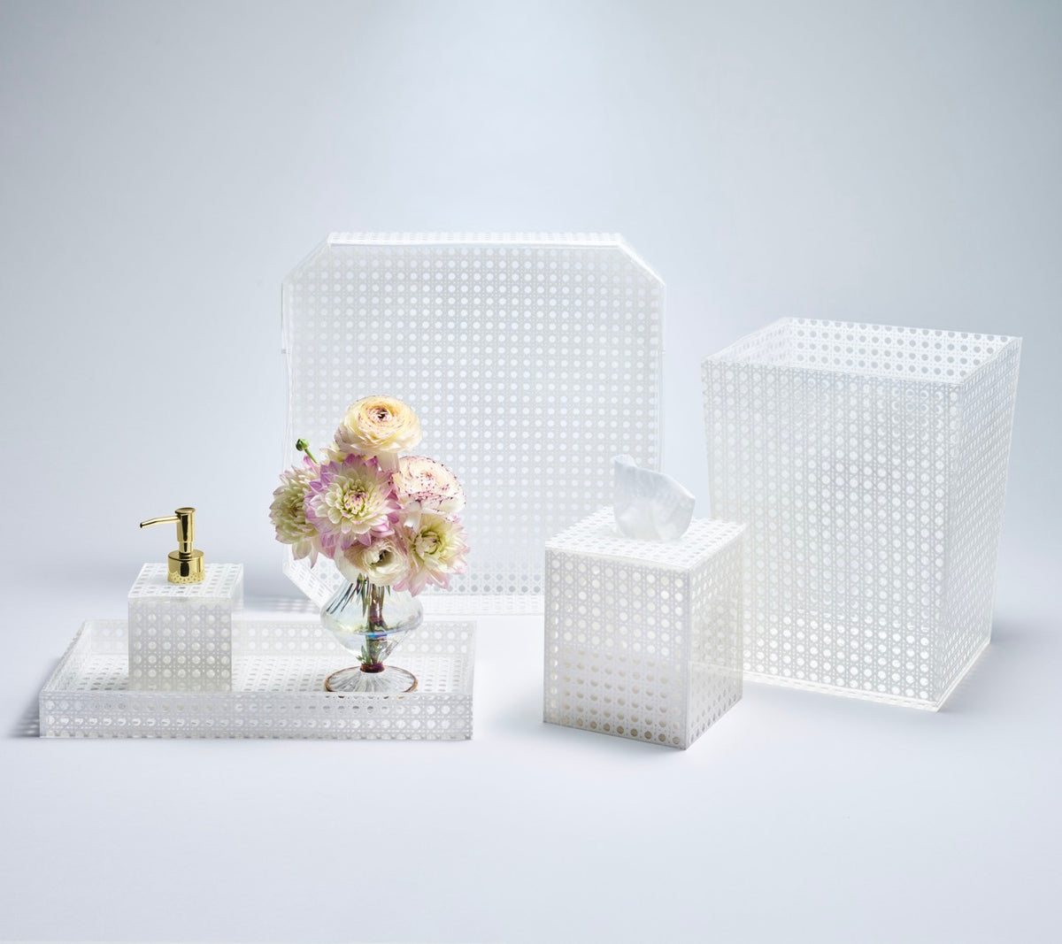 Front view of Reed Soap Dispenser in White showcasing its perforated design and gold pump with coordinating white accessories