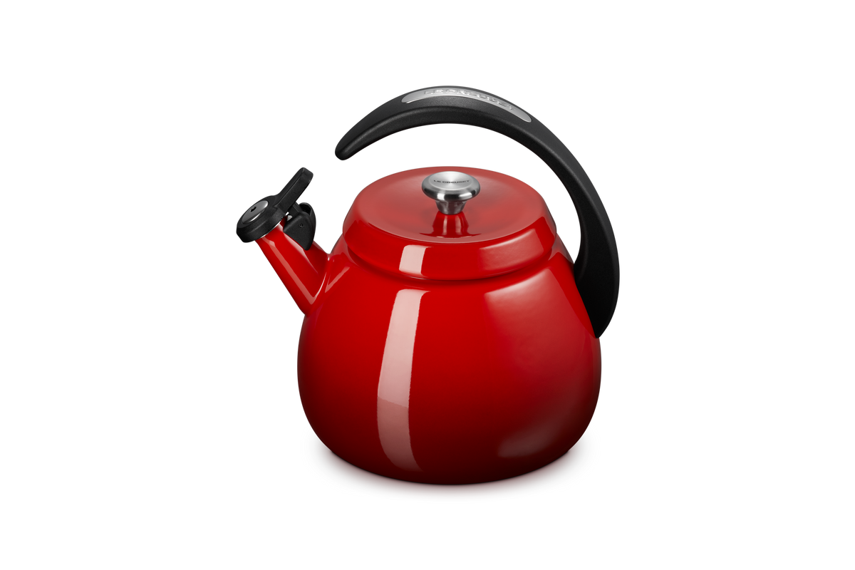 Three-quarter view of Cloche Kettle in Cerise showcasing its halo-style handle and glossy enamel finish against a gray background