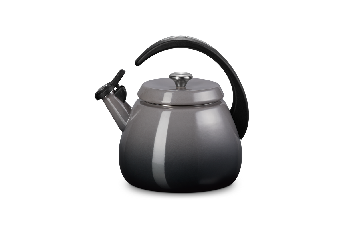 Close-up view of Cloche Kettle in Oyster showcasing halo-style handle and glossy enamel finish on gray background