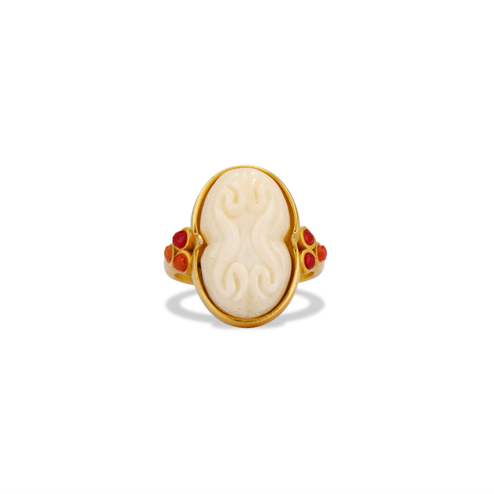 Front view of Cinched Cameo Ring with hand-carved bone cameo, gold setting, and three carnelian stones on white background