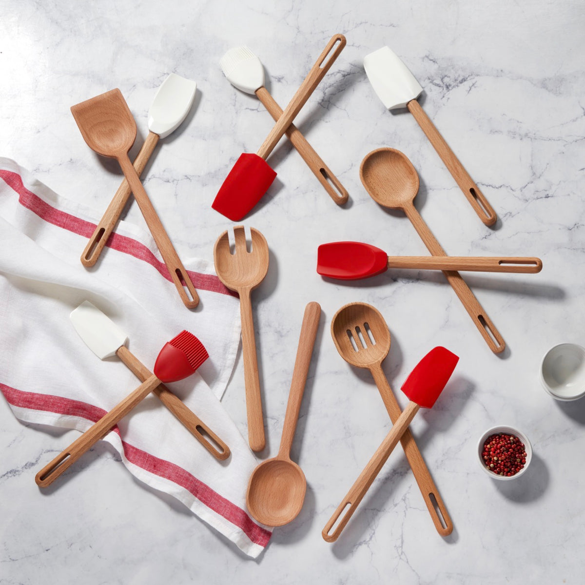 Overhead view of Signature Silicone medium spatula in white with heat-resistant silicone head and wood handle on marble background