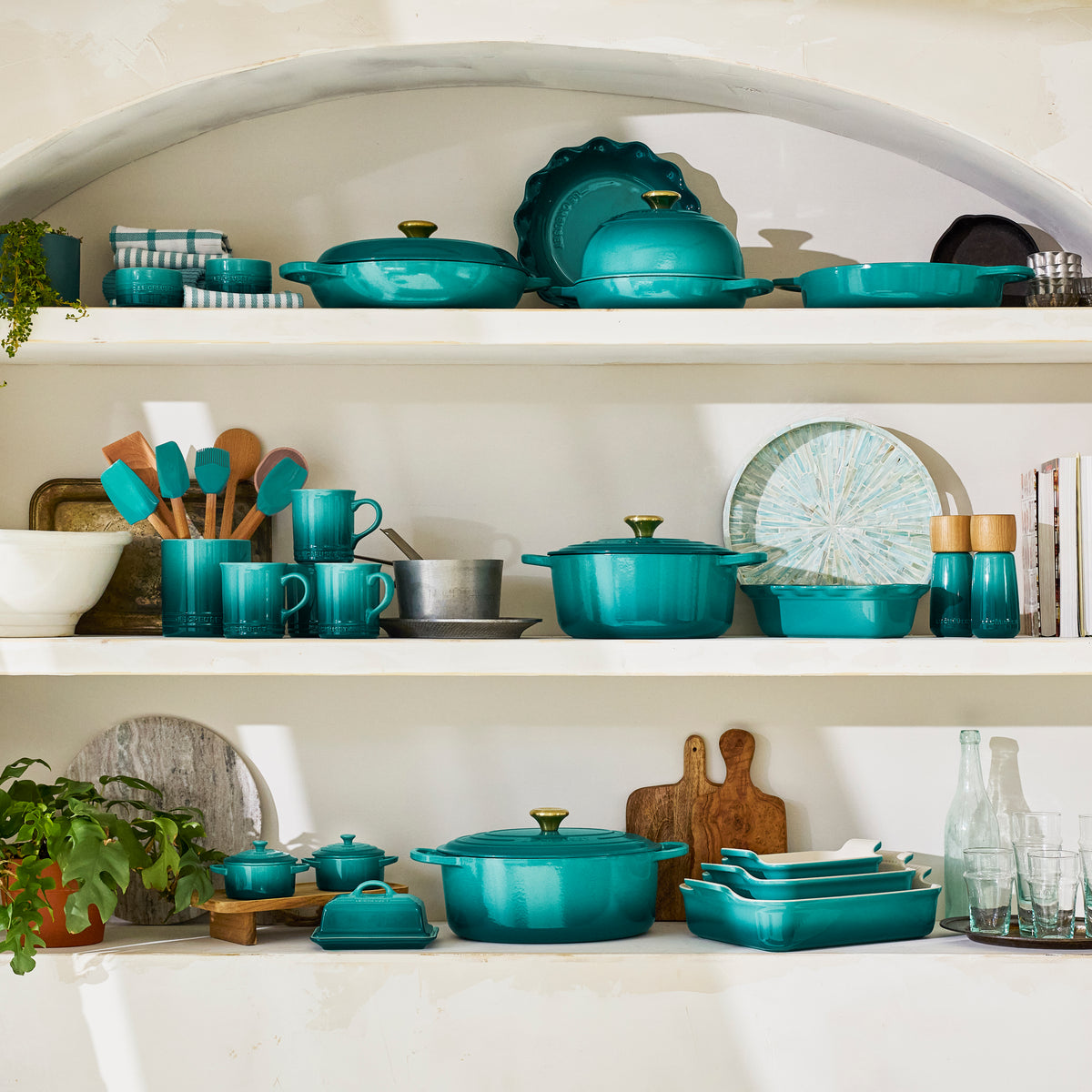 Riviera turquoise cookware collection displayed on white kitchen shelves with 6 inch butter dish among matching pieces