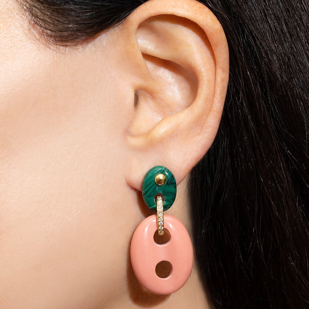 Close-up of Mariner Link earrings showing green malachite top, diamond pave link, and pink coral oval drop on a model’s ear