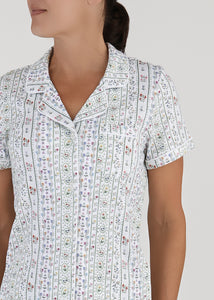 Front view of Women’s Garden Party Short Pajama Set showcasing its collared, short-sleeve floral top with a gray background