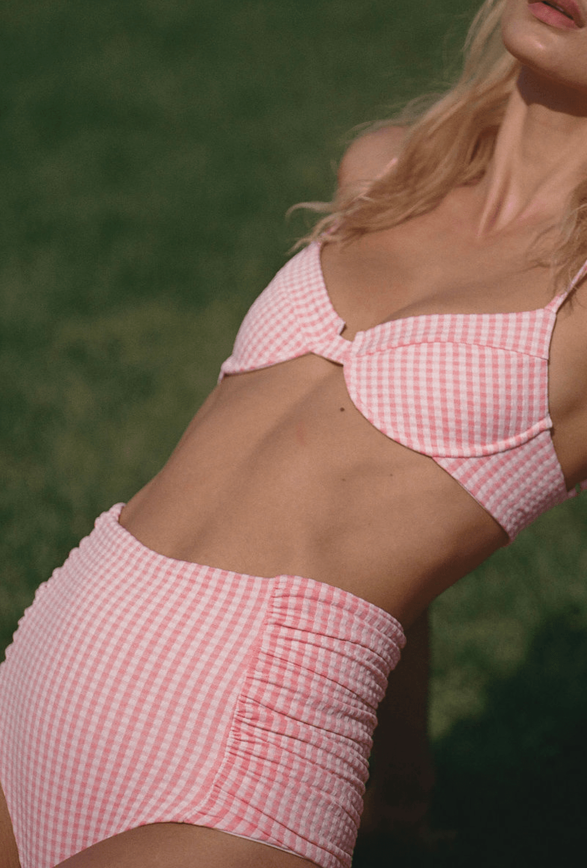 Front close-up of The Lulu Top in primrose plaid on model showing underwire cups, adjustable straps, and pink gingham
