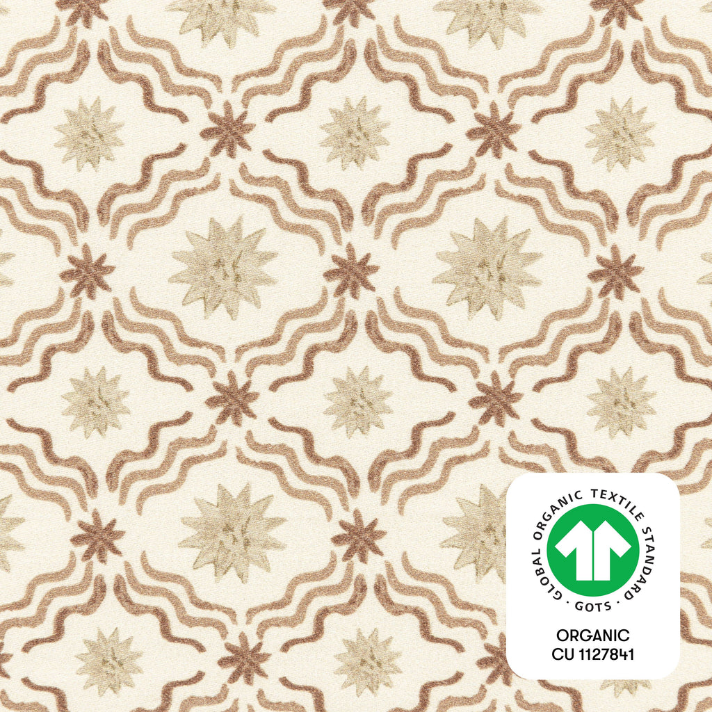 Close-up of Autumn Star crib sheet showcasing a cream star and wave pattern with GOTS organic textile badge