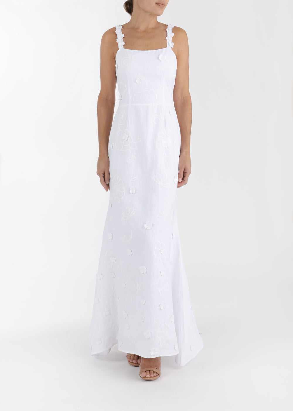 Front view of Alexandra maxi dress in white with square neckline, ruffle shoulder straps, fitted waist, and floral applique