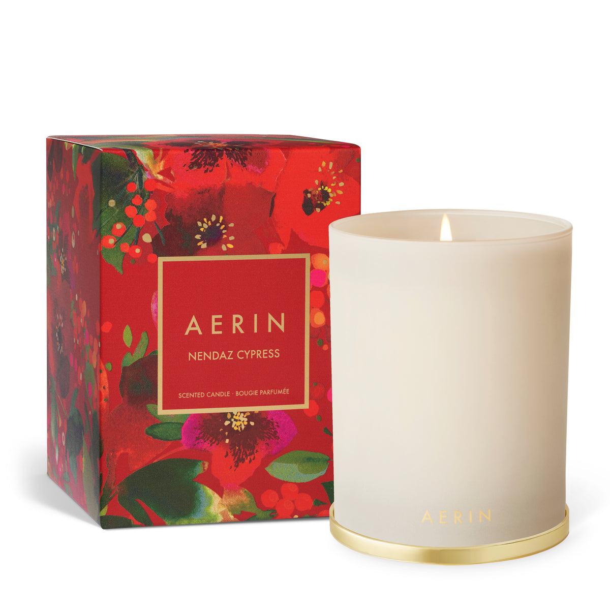Close view of Holiday Nendaz Cypress Candle in Cream showcasing its red and green floral patterned glass vessel on a white background