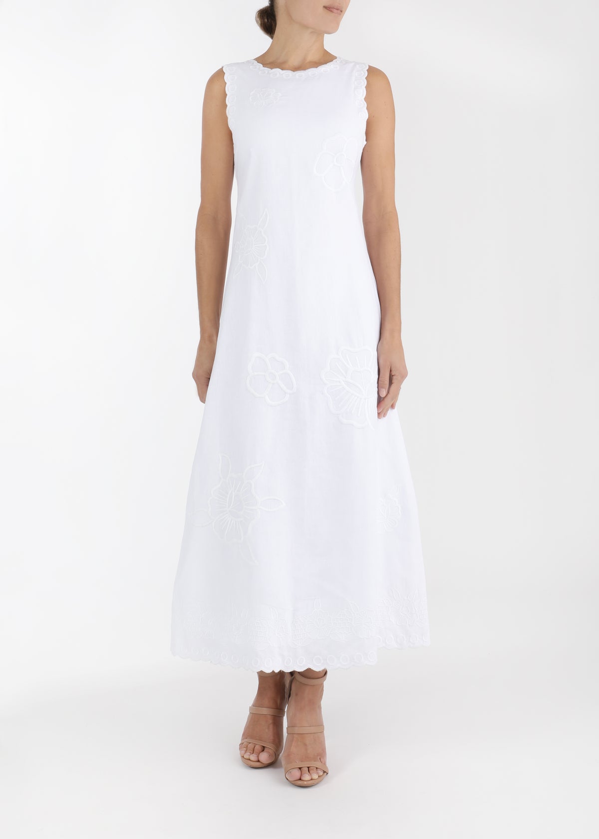 Front view of Vera midi dress on model, white sleeveless A-line with scalloped neckline and embroidered floral details