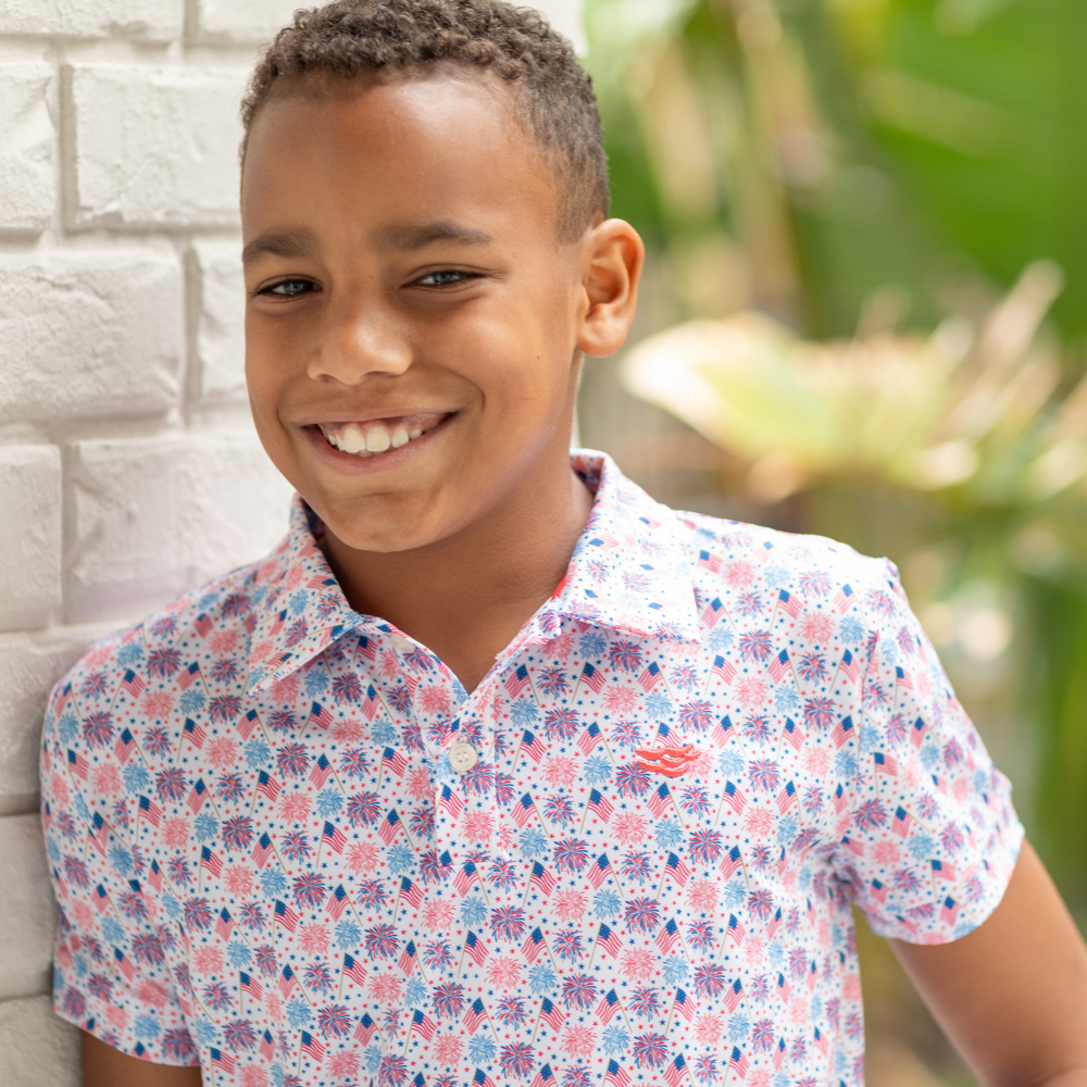 Henry Duvall boys patriotic performance polo with red white and blue fireworks and flag print, preppy UPF summer shirt for Memorial Day, 4th of July, and everyday wear