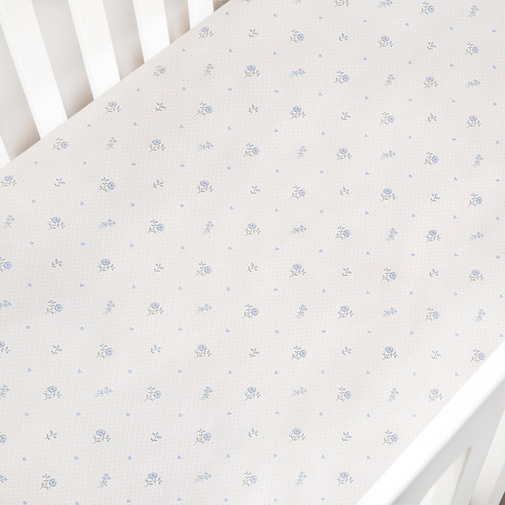 Floral patterned crib sheet on a white crib