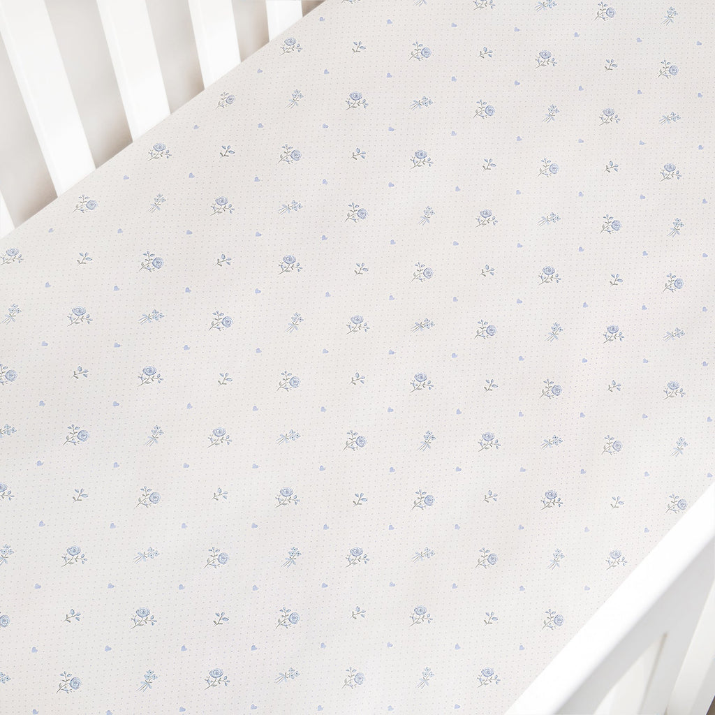 Floral patterned crib sheet on a white crib