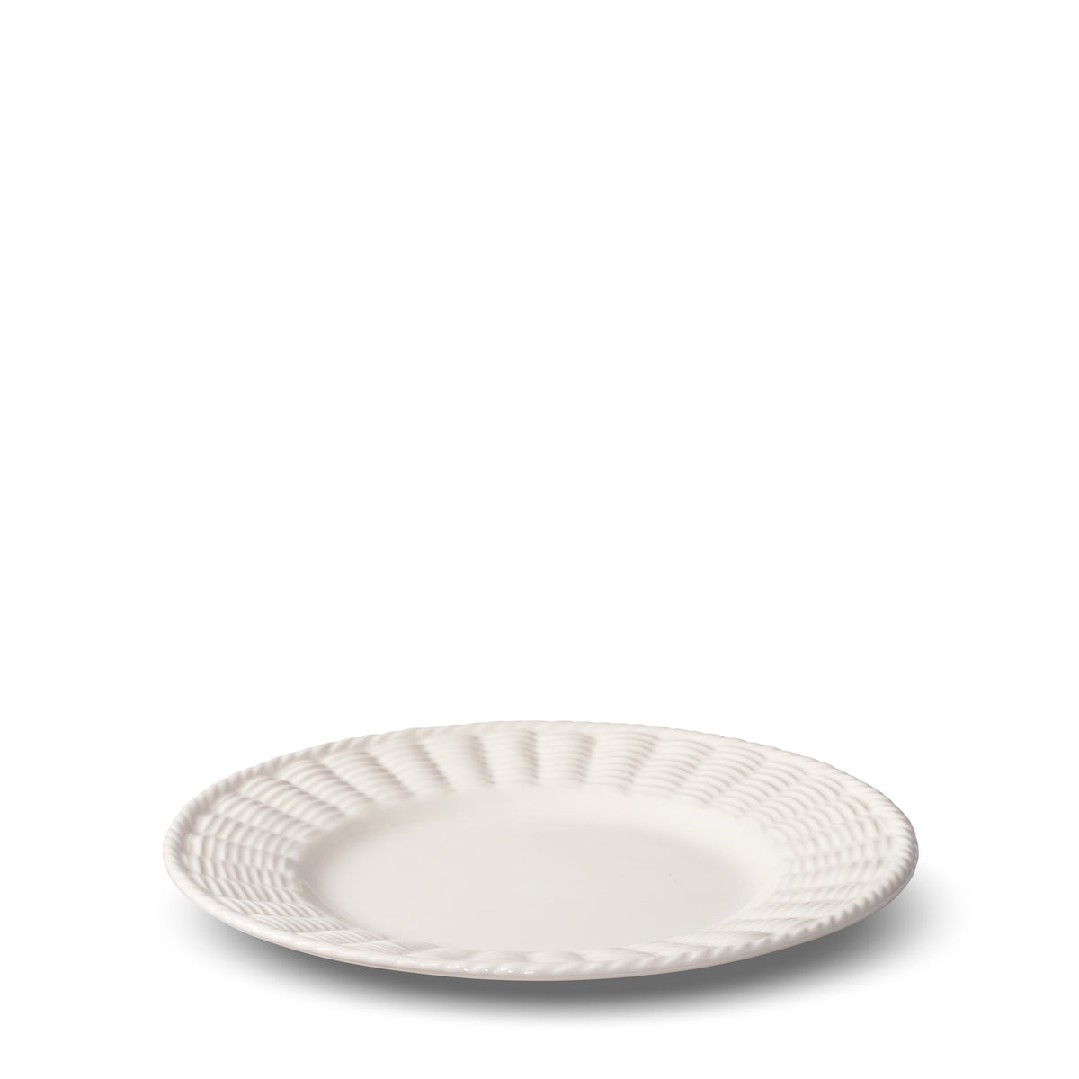 Angled view of Leta Salad Plate showcasing white ceramic and textured trim inspired by rattan basketry with a white background