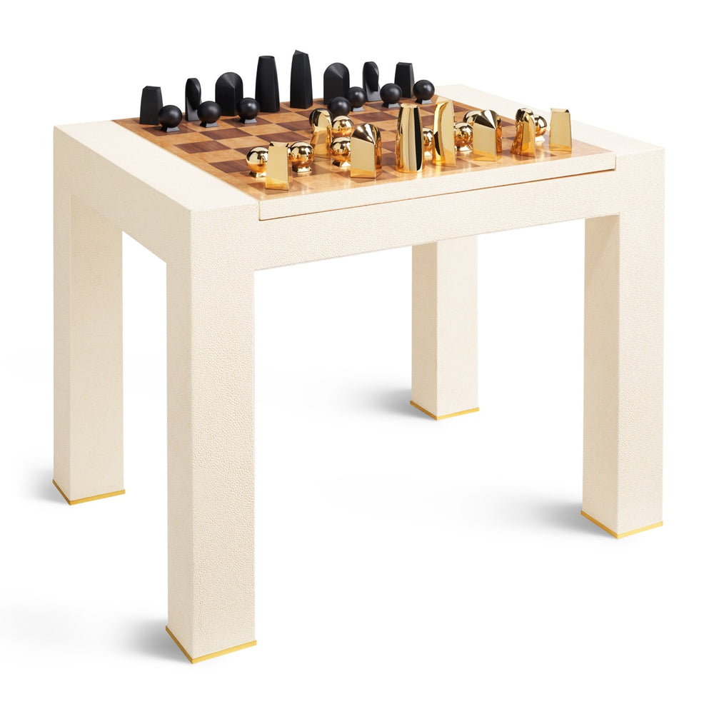 Angled view of Shagreen Chess Side Table in cream with wood chessboard, black and gold pieces and brass-trimmed legs