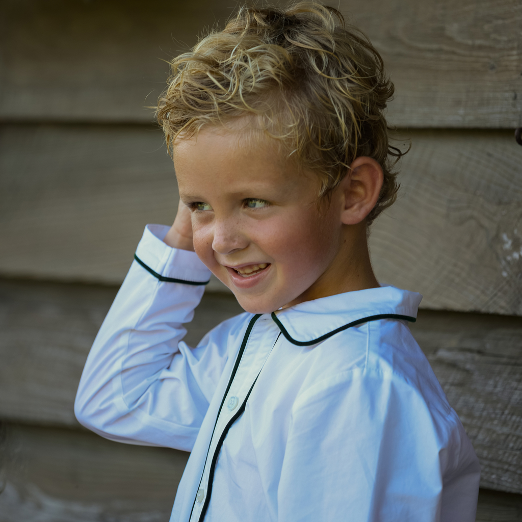 Close-up of Sullivan Shorts Set in Grafton Green Velvet showcasing a white Peter Pan collar shirt with green piping on a child