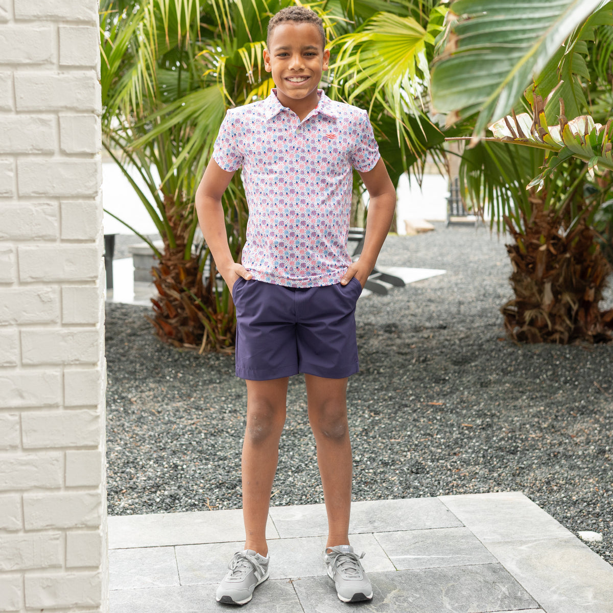 Henry Duvall boys patriotic performance polo with red white and blue fireworks and flag print, preppy UPF summer shirt for Memorial Day, 4th of July, and everyday wear