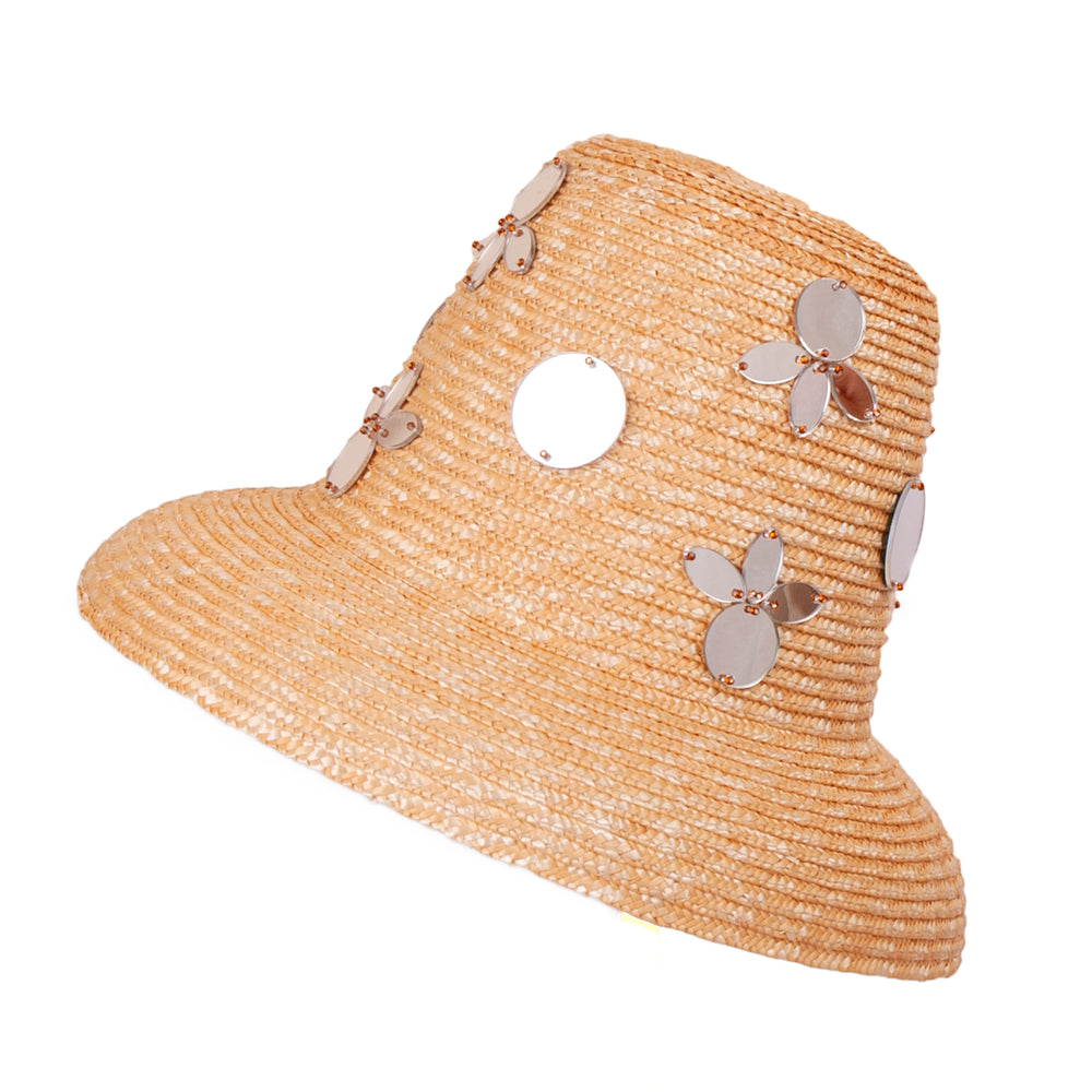 Three-quarter view of Shisha Hat showcasing natural raffia weave and reflective mirror embellishments on a white background