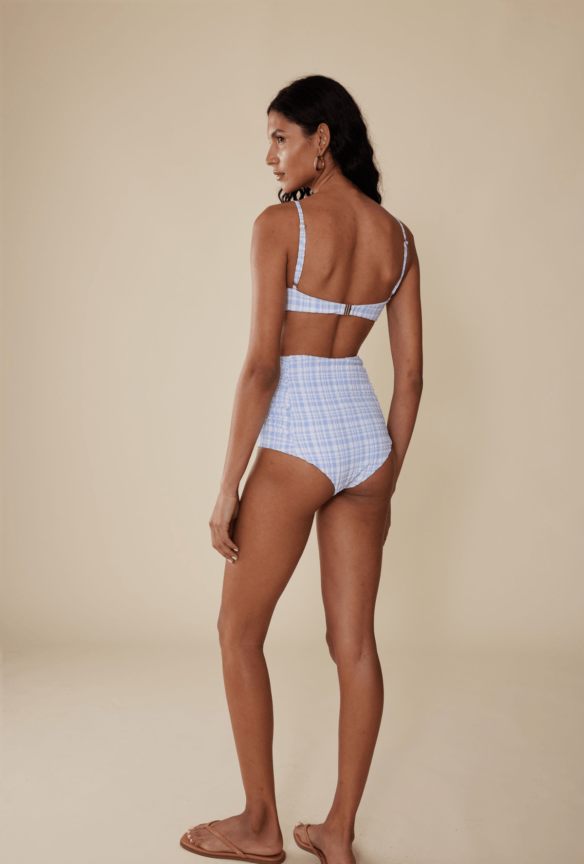 Rear view of The Luisa Bottom in Birdie showcasing high-waisted fit and ruched side panels on beige studio background